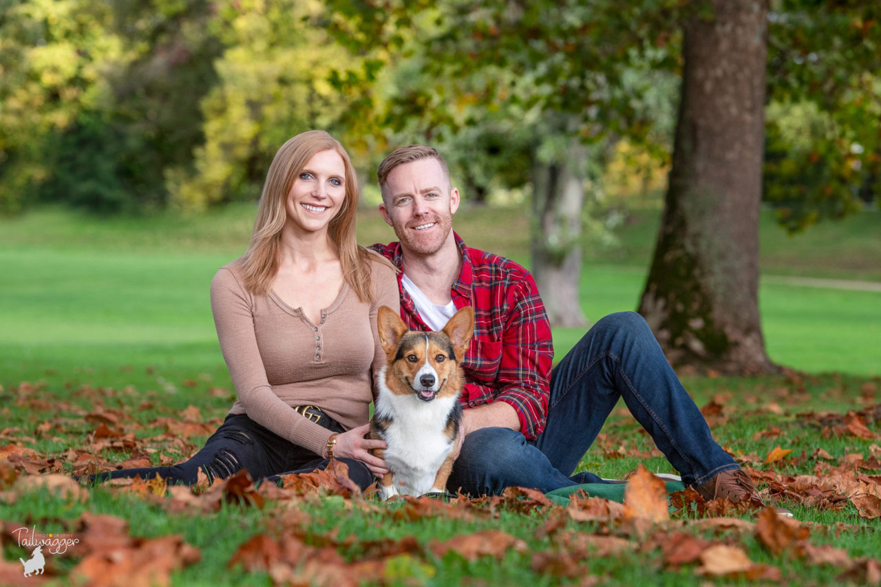 A man and woman pose with their tri colored Corgi in Grand Rapids, MI.