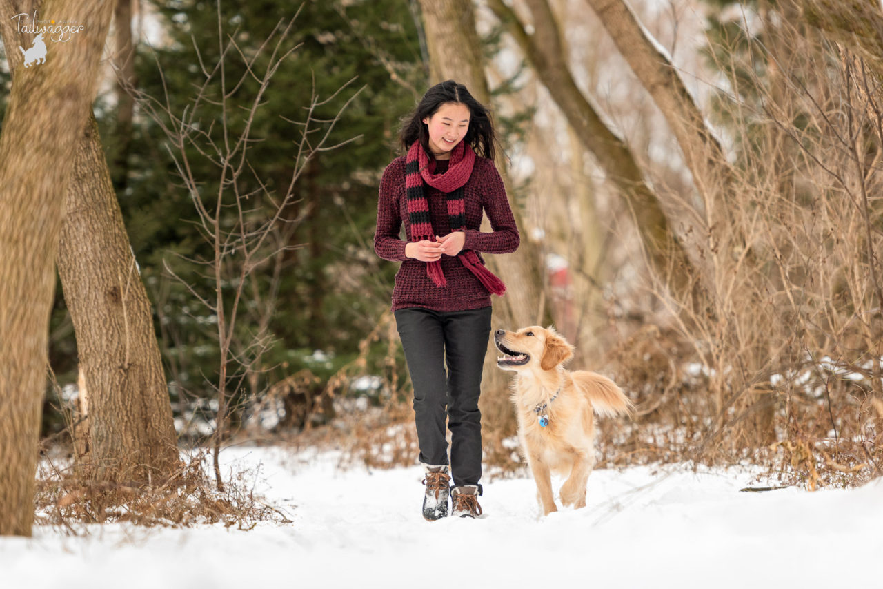 A young woman walks in the woods with her Golden Retriever in Wayland, MI.